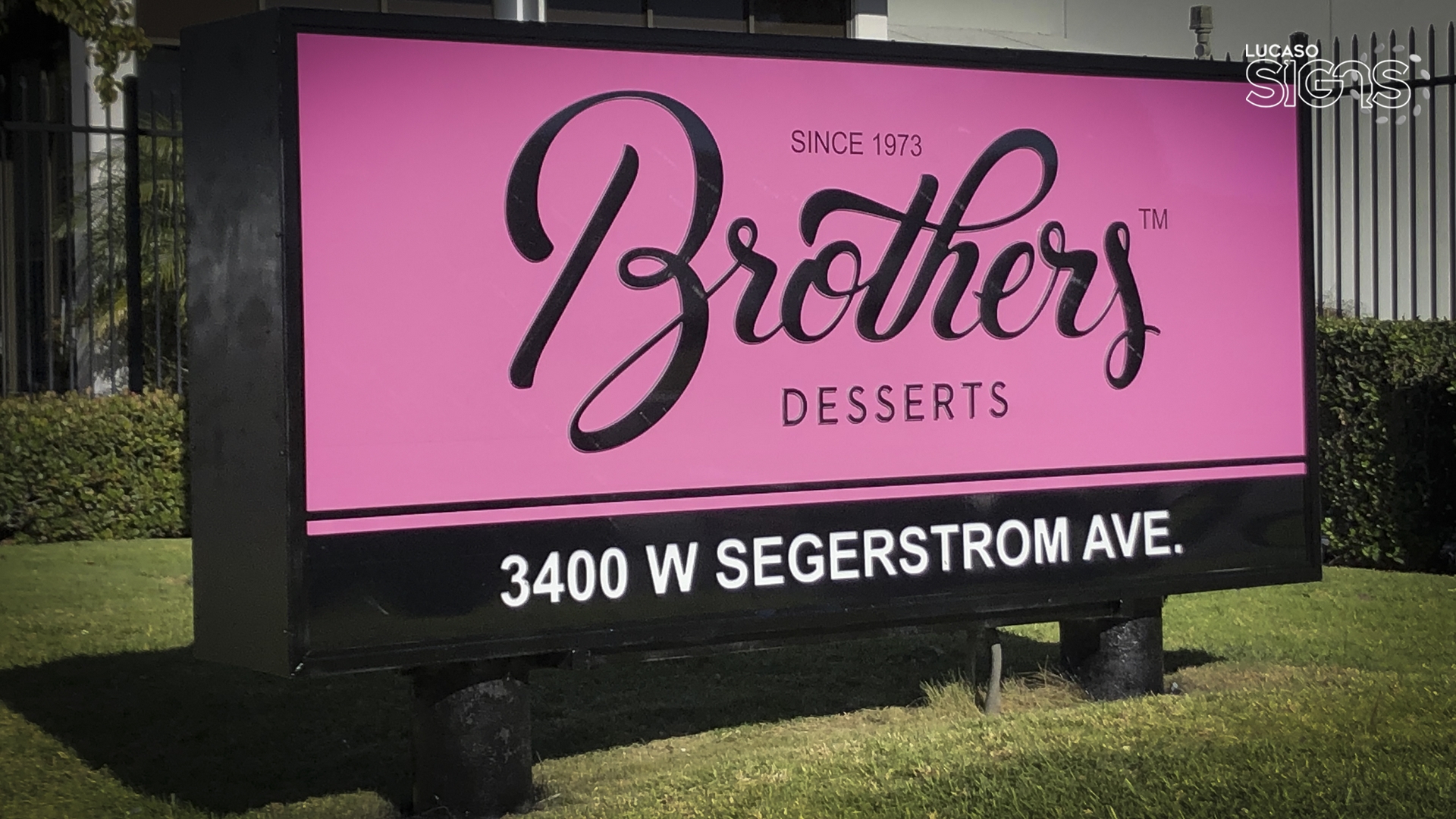 Custom monument light box sign with pink background and black lettering for Brothers Desserts by Lucaso Signs
