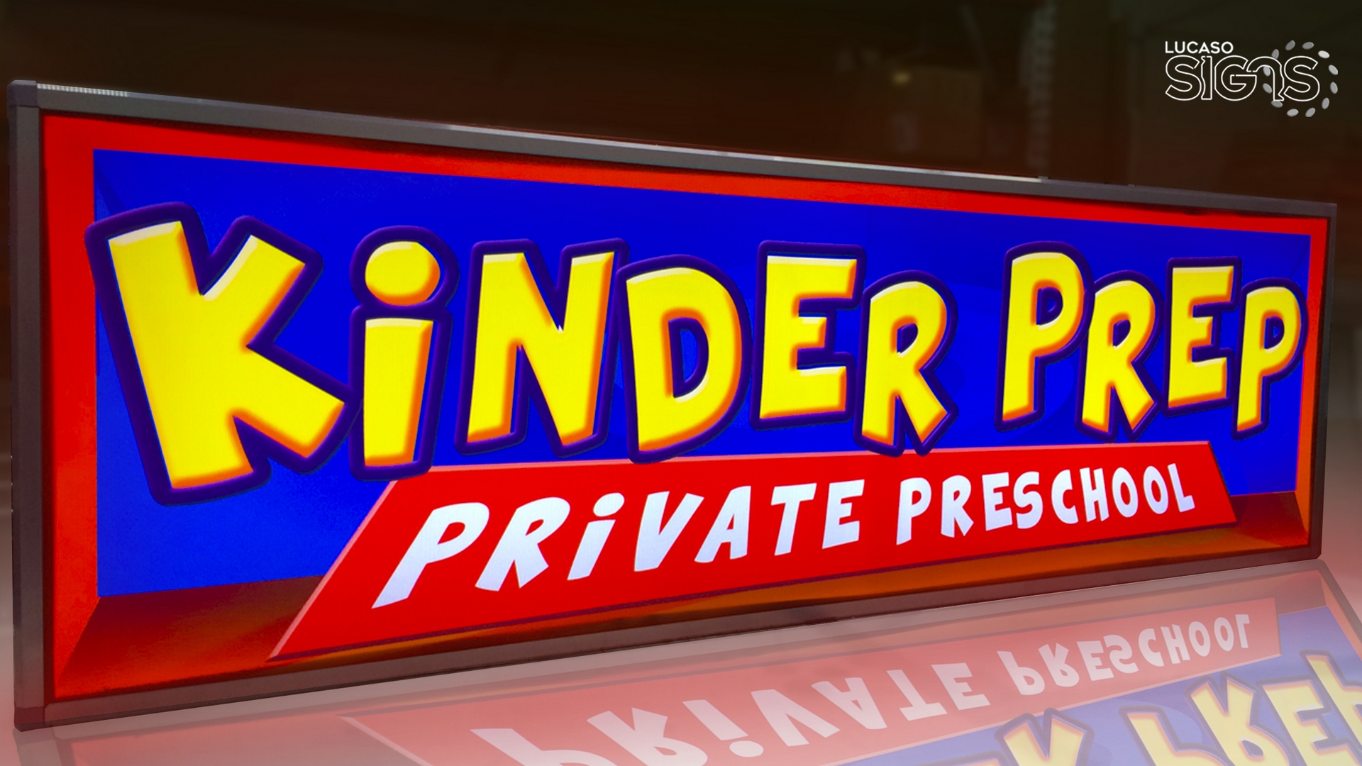 Custom illuminated light box sign with vibrant red, blue, and yellow graphics for Kinder Prep Private Preschool by Lucaso Signs