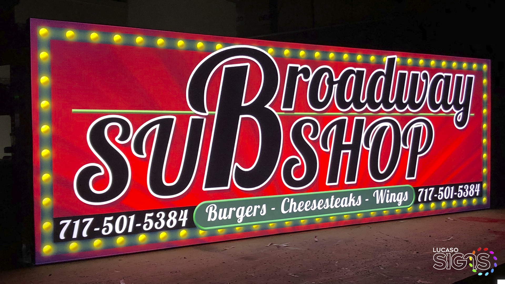 Custom illuminated light box sign for Broadway Sub Shop with vibrant red background, marquee-style bulbs, and bold lettering by Lucaso Signs