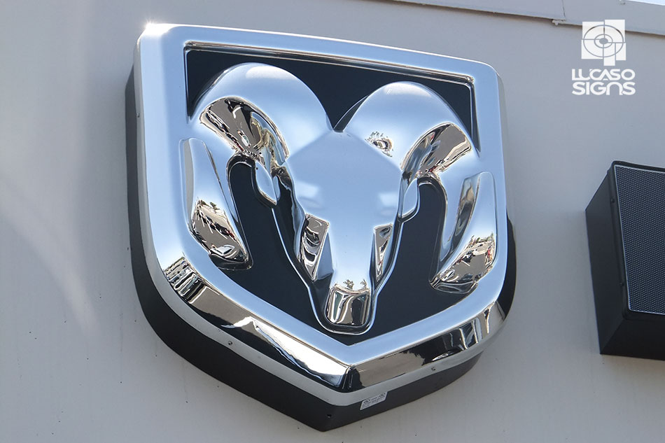 Chrome thermoformed 3D Dodge Ram logo emblem mounted on black background, durable automotive branding by Lucaso Signs