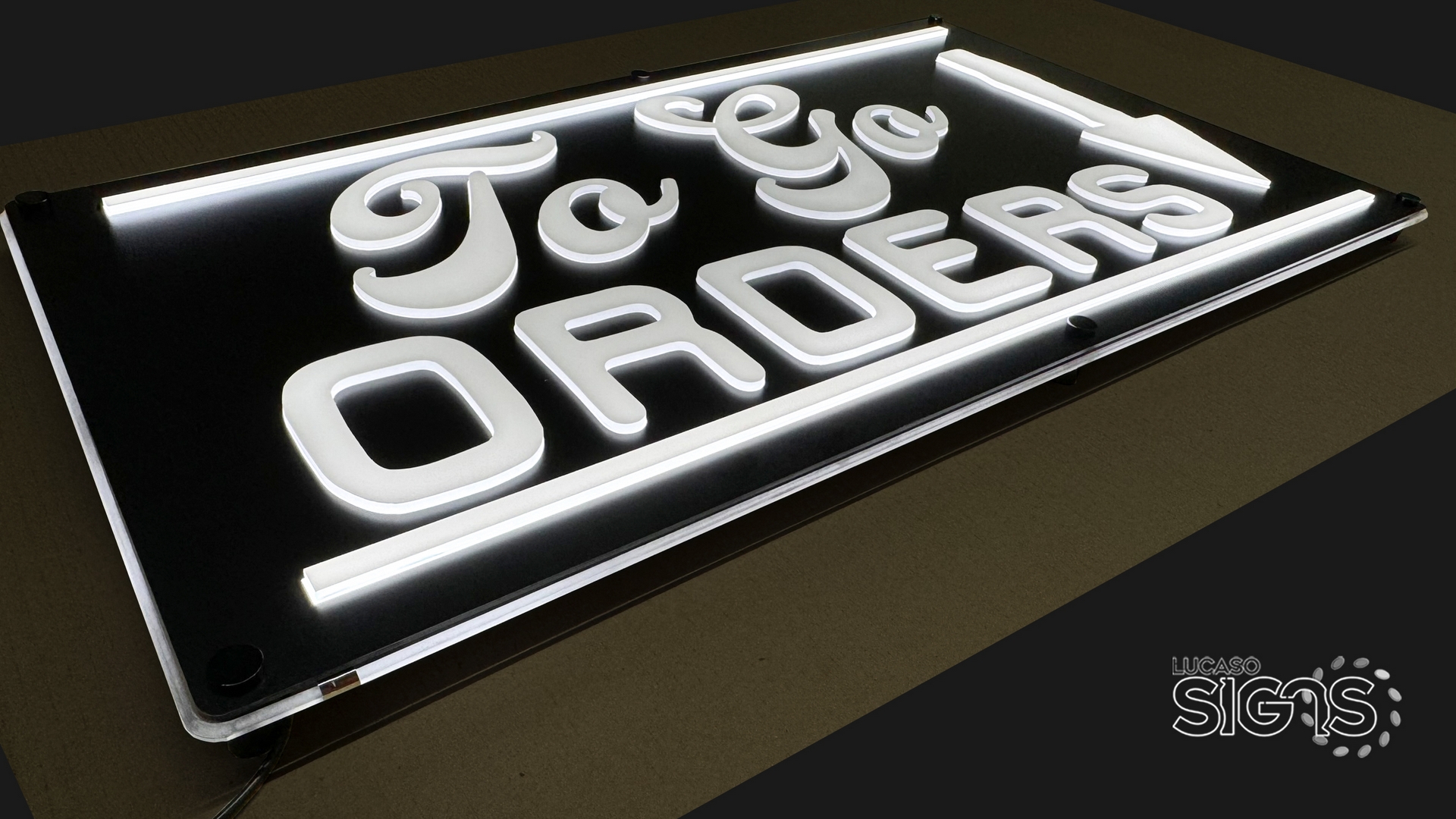 Custom push-through illuminated sign with white glowing letters spelling To Go Orders by Lucaso Signs